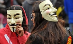 Protesters wearing Guy Fawkes masks gather outside St Paul's