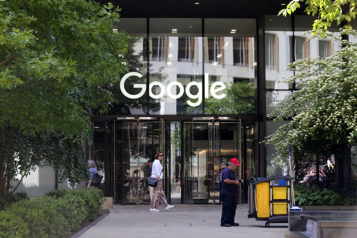 People walk past a set of revolving doors at one of Google's headquarters.