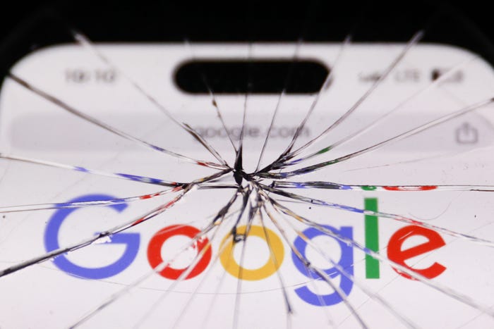 Google logo displayed on a cracked mobile phone screen.