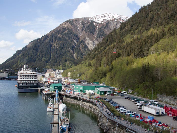 A view of a cruise ship moored in Juneau, Alaska, in springtime with Juneau Mountain in the background.