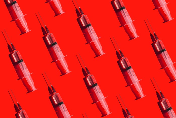 Syringes against a red background