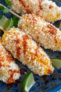 A quintessential Mexican snack, elotes is a traditional street food made with roasted corn. #Mexico #Foodie #May