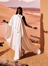 White crepe jumpsuit, with an asymmetrical cape flowing gracefully onto a long train.

#TonyWard #FW24 #RTW #FallWinter #SafariSunset