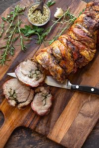 This porchetta is prepared with flavorful pork shoulder seasoned with herbs, garlic, fennel and citrus zest, then slow roasted to perfection! | thecozyapron.com #porchetta #porchettarecipe #porchettaitalian #porchettasandwich #porchettaroast #porchettaporkroast