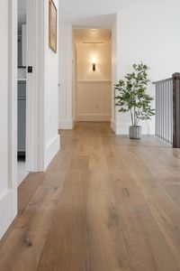 A natural coloring process highlights the depth of warm beiges and light grays in the Westport wide plank wood floors.