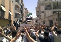 Demonstrators protest against Syria's President Bashar al-Assad after Friday Prayers in the neighbourhood of Erbeen, near Damascus, on June 8, 2012.