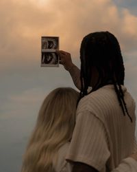 the sweetest pregnancy announcement 🩷 I’m so so so happy for you two! this day was absolutely crazy, I get to the beach and it is paaaaacked. like can’t take one photo without 20 people being in the background packed. it down poured for 5 minutes before we were supposed to start taking photos, which caused the beach to then be pretty much empty for us!! during the shoot the sky was so beautiful!! the literal face in the clouds that looks like a little baby!!! right at the end i was taking p...