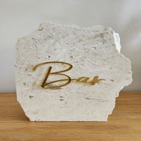 Limestone signs are sure to wow your guests no matter what the occasion. Whilst popular for weddings and engagements, they add luxury to any event. Each piece is unique in colour, shape and size. No two pieces will ever be the same. They are hand-made and paired with laser-cut acrylic lettering, adding the perfect touch to your event decor. Rough Size 20cm-25cm (All shapes will vary) Allow up to 4 weeks as all signs are made to order. Please note: shapes and sizes of the stone pieces will vary to what is pictured. As all orders are made to order pieces will be picked and lettering will be assigned at random. Orders are thoroughly packaged to avoid any damages during shipping. *Limestone is a natural stone meaning no two pieces will be exactly the same. Patterns and colours may vary and can