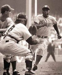 Jackie Robinson stealing HOME! Check out the batter; he doesn't seem to notice that Jackie is about to slide right under him!