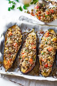 This warming stuffed eggplant is filled with basmati rice, lean ground beef, tomatoes, herbs, plus a spicy garlic tahini sauce! | thecozyapron.com #stuffedeggplantrecipes #stuffedeggplant #stuffedeggplantrecipesmeat #stuffedeggplantrecipeshealthy #garlictahinisauce