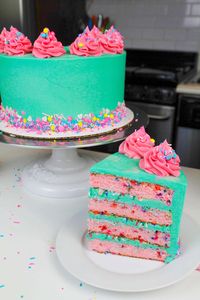 Sliced funfetti cake, with bright blue frosting