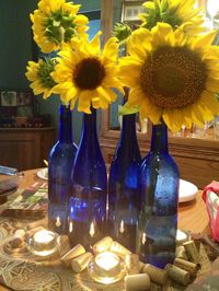 Blue wine bottles, wine corks, sunflowers and candles!  Keep it simple.