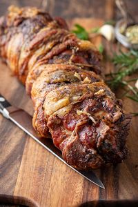 This porchetta is prepared with flavorful pork shoulder seasoned with herbs, garlic, fennel and citrus zest, then slow roasted to perfection! | thecozyapron.com #porchetta #porchettarecipe #porchettaitalian #porchettasandwich #porchettaroast #porchettaporkroast