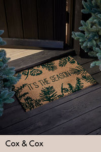 Add a festive welcome to your front door with this seasonal doormat. Crafted out of naturally durable coir, its neutral tones mean this mat blends with any interior scheme.

With a festive phrase in the centre and fir leaf surrounding the border, a subtle touch of Christmas is added to your door. 