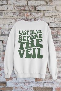 Camp in style with the Last Trail Before The Veil sweatshirts! These fun sweatshirts are perfect for celebrating your bachelorette with your closest friends wherever you are camping, hiking, or getting wild the woods. These fun bachelorette party shirts feature a wavy retro font style back design, perfect for the camp bachelorette theme of your dreams. The perfect addition to your outfit for group photos and Instagram-worthy moments. Product Details: -- 50% cotton, 50% polyester -- Medium-heavy fabric (8.0 oz/yd² (271.25 g/m -- Loose fit -- Sewn-in label -- Unisex style, runs true to size. Size up for long oversized fit.