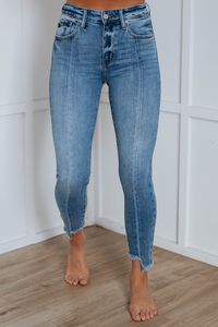 Details: Halton KanCan Jeans High Rise No Distressing Skinny Fit Fading/Whiskering Paneled Cut Seam Detailing Asymmetrical Raw Edge Frayed Hems Good Stretch Zip Fly Button Closure Available in Medium Wash Rise: 10" Inseam: 25.5" (Shorter Side) 27" (Longer Side) Leg Opening: 9" Material: 93% Cotton, 5% Polyester, and 2% Spandex We are recommending true to size!