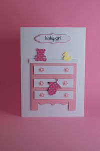 Handmade New Baby or Baby Shower card with a chest of drawers in either Pink or Blue with Teddy, Duck and Vest on coat Hanger. Card Size: 5″x 7″ Blank Inside Envelope included Please allow 14 days for delivery to the USA. Like us on Facebook www.facebook.com/Tangledcrafts to see