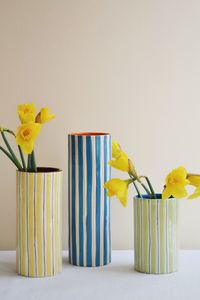 This blue and orange striped vase was designed to add style to any table setting. The striped pattern is hand painted and is irregular in shape, giving the vase a unique look. A stunning vase for flowers, branches or to store kitchen utensils. PRODUCT DETAILS H: 23.5 D: 8cm Material: Porcelain Rinse with lukewarm water for cleaning