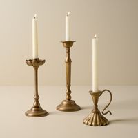 This taper holder is inspired by an eclectic grouping of candlesticks Jo saw on a trip to New York City. Made of aluminum, this holder safely supports standard taper candles to light up any mantel or tablescape. It comes in three different height and design options that look cohesive when grouped together.