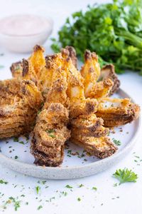 Recreate Outback's classic Blooming Onion at home with this healthier air fryer recipe! You'll learn the easiest way to cut a blooming onion, the best method for coating it in breadcrumbs, and then the perfect time and temperature to air fry so it comes out beautifully golden, crisp, and tender. Serve it up with a side of blooming onion dipping sauce for a delicious appetizer or party snack!