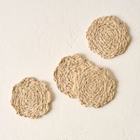 Made of raffia palm in a light finish, the Vera Bleached Coaster Set features four flower-shaped coasters to help protect your table while adding natural charm. Pairs well with the Vera Bleached Oval Flower Placemat.