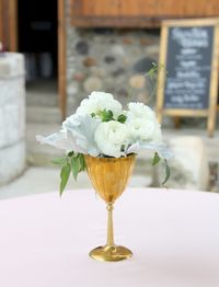 Vintage Brass Goblet cocktail table floral arrangement with white ranunculus dusty miller and jasmine vine. Misty Valley Sweet Pea floral Design Ann Arbor Detroit