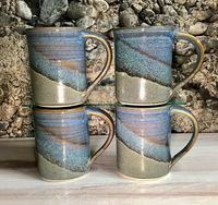 Set of four handmade mugs in Slate Twilight glaze. All of our pottery is lead free, food, dishwasher, oven, and microwave safe. Each piece has slight variations and the artist's signature and year on the bottom, letting you know that they came straight from our pottery studio to your home! This listing is for a set of four Slate Twilight mugs Mug: 4 ½" tall by 3" wide, plus handle Capacity: 14 oz. As beautiful as they are purposeful. A mindful and simple design that will function beautifully in