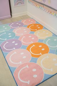 The big and happy smiley faces on this rug are sure to bring instant cheer! And the pastel rainbow palette with the blue background makes this bright and beautiful rug a showstopper! This rug coordinates beautifully with many of the Schoolgirl Style classroom decor themes! Schoolgirl Style classroom rugs are the crowning jewel in classroom decor, and THE perfect finishing touch. The colors coordinate beautifully with many of the our collections, and the texture is oh-so-soft and comforting for a