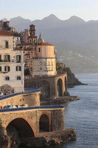 size: 24x16in Photographic Print: Church of Santa Maria Maddalena and Coast Road with Mountains by Eleanor Scriven :