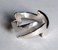 "The Lightning Bolt symbolizes many things to people in different world cultures: honesty, fertility, strength, intellect, illumination..union of fire and water, power, swiftness, just to name a few...To me, it symbolizes sudden divine inspiration, truth & energy. I love this symbol!  Cast in solid Sterling Silver with a hammered finish, this wrap-around ring can be adjusted to fit US sizes 4-9. This is a variation of my original lightning bolt ring but has 2 tapered ends, instead of 1 wide and