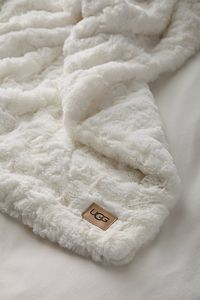 A luxuriously plush faux fur throw blanket from UGG, this blanket features a chenille knit fabrication that’s super soft and feels like classic UGG. This faux fur throw blanket is perfect for spreading across your bed or sofa to create a lavish and cozy space. Features UGG Adalee Faux Fur Throw Blanket Plush chenille knit fabrication feels so luxurious against your skin Add to your bed or drape it over the sofa, the light-but-warm feel is cozy anywhere Faux Leather Logo Labels Content + Care 100