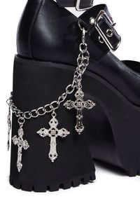 and damned if I don't! These faux leather mary janes have adjustable buckle straps with grommet hardware, dangling chains with cross charms, and treaded platform soles.