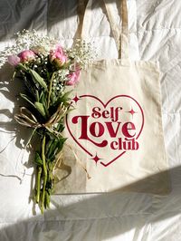 "Self Love Club lightweight canvas tote bag made with 100% cotton. Perfect for markets, shopping, picnics and everyday use!  Design colours can be completely customizable with different coloured letters or heart/stars. Let us know in the personalization box of any customizations! *design is only on one side of the tote bag.  Dimensions: 15\" W x 16\" H. Holds up to 10lbs. Curbside pickup in Vaughan, ON available. Please message us after placing your order for this option! SHIPPING OPTIONS: Withi