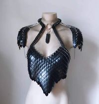 This piece is a one of kind item made by Synthetic Daisy designs.  Constructed out of a combination of scalemail pieces with bright aluminum chainmail. Shoulder pauldrons clip on & off.  Has a built in necklace.                                                        Check out my website for more items exclusively sold only there. www.syntheticdaisydesign.com