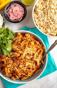 Slow cooker Mexican shredded chicken is just 3 easy ingredients and minutes to prep, but has such delicious flavor! Use it for tacos, nachos, grain bowls, sliders, salads and more!