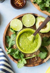 Five minute, thick and creamy Avocado Cilantro Lime Dressing - this fresh, zesty sauce is easy to make while also packing in a punch! Use as a healthy dressing to top off salads, dipping veggies or serve over meats like chicken and shrimp. | #HealthyGlutenFree + #Vegan + #Paleo + #Keto  #CilantroLime #HomemadeDressing #Avocado #SaladRecipes