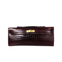 Hermès Burgundy Shiny Niloticus Gold HDW 2015 Kelly Cut Pochette Clutch | From a collection of rare vintage clutches at https://www.1stdibs.com/fashion/handbags-purses-bags/clutches/