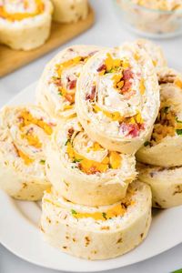 Take your appetizer and snack game up with these easy Chicken Bacon Ranch Pinwheels! These savory rollups feature a combination of tender chicken, crispy bacon, and creamy ranch all wrapped in a fluffy tortilla. Perfect for parties, potlucks, or as a tasty snack, these pinwheels are a crowd-pleasing snack.