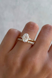 Elegant Bridal Ring Set pairs a stunning Oval trilogy engagement ring with a classic pave wedding ring. Featuring the Elena Engagement Ring and Joanna Wedding Band. wedding band and engagement ring wedding band rings wedding ring set wedding rings simple wedding ring sets