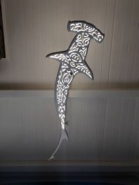 We offer a new, very beautiful handmade ceiling lamp. The lamp with the silhouette of a shark hammer with a drawing in the Maori style. It will not only be a beautiful element of the interior. Every night you will be immersed in the ocean. It can decorate any interior - children's room, living room, office. It will attract attention everywhere. Size - 50 x 16.1 x 1.1 inch. Light - LED strip, 12 volts. Since you are interested in buying a lamp, can you take a look at our other lamps then?) We wil