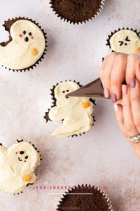 Get the recipe for these spooky sweet Triple Chocolate Ghost Cupcakes! These chocolate Halloween cupcakes are studded with chocolate chips, topped with white chocolate buttercream and decorated with irresistibly cute ghost faces. They’re the perfect treat for a Halloween party, celebration or to mark the occasion! Find more Halloween treats and Halloween recipes here: Jessiebakecakes.com