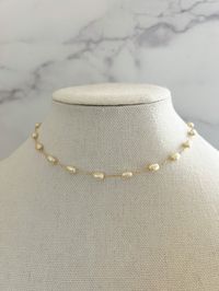 "Pearl Necklace - made from porcelain pearls, detailed on an 18k gold filled chain, and has an extender chain attached for different lengths.   This simple and dainty Pearl necklace is perfect for everyday wear- even into the night! Necklace length: 15 3/4\" with 2\" extender Porcelain Pearl Size: 4mm Material: 18k Gold Filled Chain"