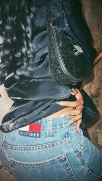 Sparkly black purse  • Black purse  • curly hair in ponytail   • Tommy Hilfiger jeans  • Denim jeans  • Aesthetic post  • Close up shot  • Detail shot  • Film photography