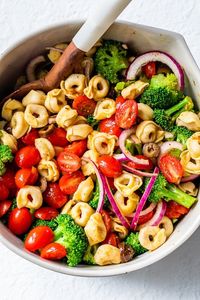 This easy garden Tortellini Salad with is the perfect BBQ side dish made with cheese tortellini, summer tomatoes, broccoli florets, and black olives. #bbqsides #sidedish #tortellini #tortellinisalad #pastasalad