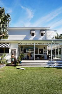 Fretwork around the verandah was designed to represent the family. “The cross being Stephen and I, and the three posts in between are the boys,” says homeowner Kimberly. “The palms are all handmade; the house is called Little Palm.”: [object Object]