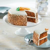 Our HoneyBaked Carrot Cake is the perfect culinary conclusion to any large meal or gathering. Each cake bursts with flavor and texture, thanks to multiple layers of high-quality ingredients. Every mouth-watering bite contains the perfect balance of fluffiness and melt-on-the-tongue creaminess.   Each HoneyBaked cake is stuffed with a rich mixture of fresh shredded carrots, walnuts and sweet raisins. A smooth cream cheese frosting is spread over the top and between each cake layer to create visua