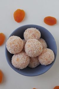 Overhead view ofThemomix Apricot Balls sitting in a blue dish.