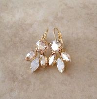 Gorgeous pair of crystal leaf earrings featuring sparkling champagne and white opal marquis, and round champagne crystals. Available in Rose gold or gold plated settings. Please select desired metal finish from the drop down menu at check out. From ear piercing, the earrings are 1 1/4 long and 5/8 | Wedding Earrings