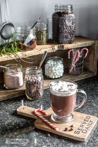 Rustic Christmas hot cocoa station in a crate, with cutting board styled coaster, part of Funky Junk's Christmas home tour. See it all at funkyjunkinteriors.net #christmas