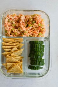 Birds eye of adult lunchable with spicy tuna salad, cucumbers and crackers.